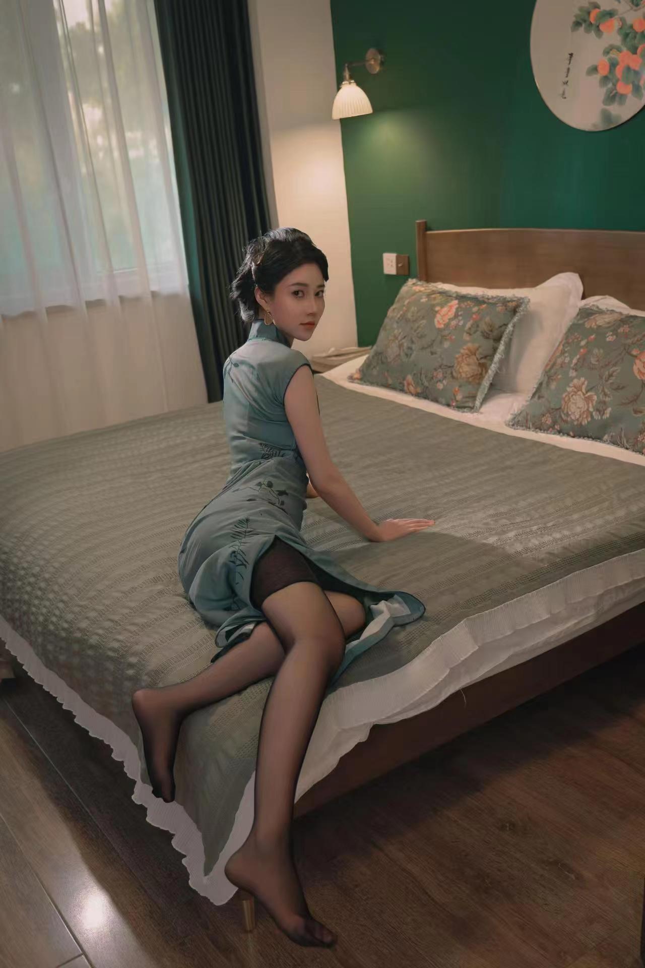 The moonlight shone through the window lattice, tracing her straight spine, the satin faintly revealed the warmth of jade, and even the folds of her skirt were solidified into the tranquility of a fine brush painting.